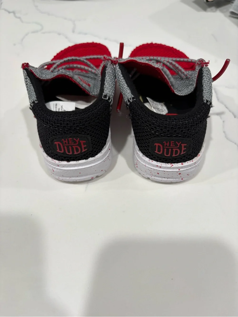 Hey Dude Kids Red and Gray Slip-On shoes.
